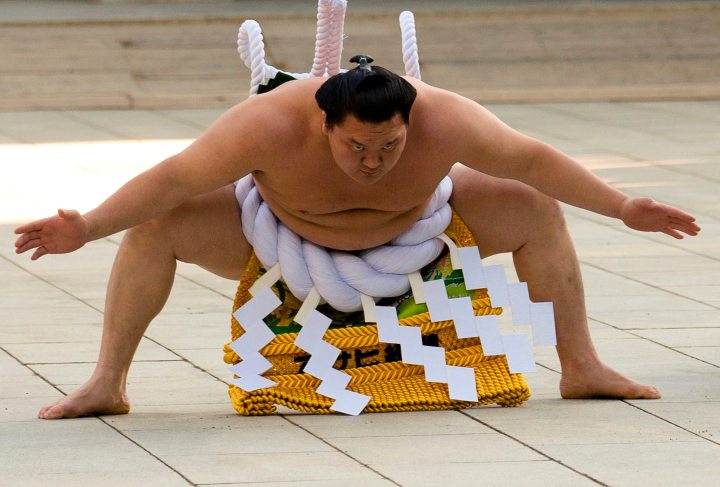 Mongolian-born grand sumo champion Yokozuna Hakuho performs New Year's ring-entering rite at annual celebration for New Year at Meiji Shrine in Tokyo